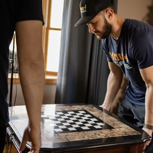 Move and Care mover carefully setting down a chess table during a move