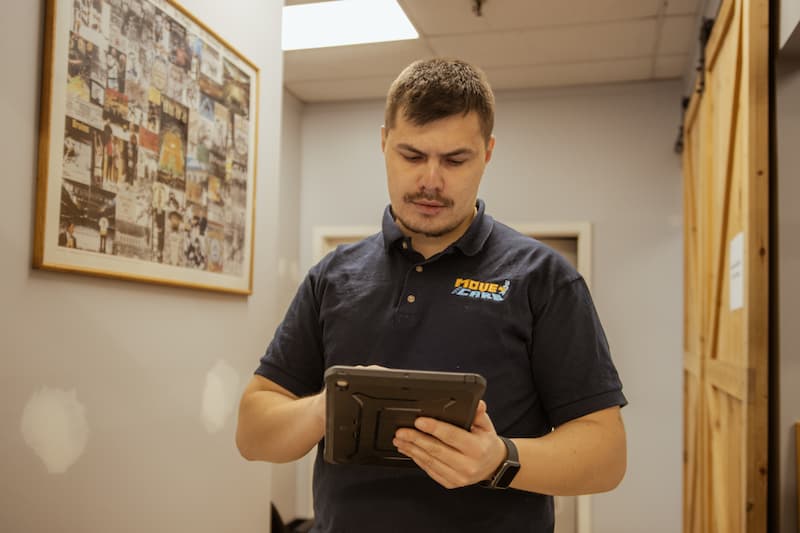 Move and Care coordinator checking a move plan on a tablet