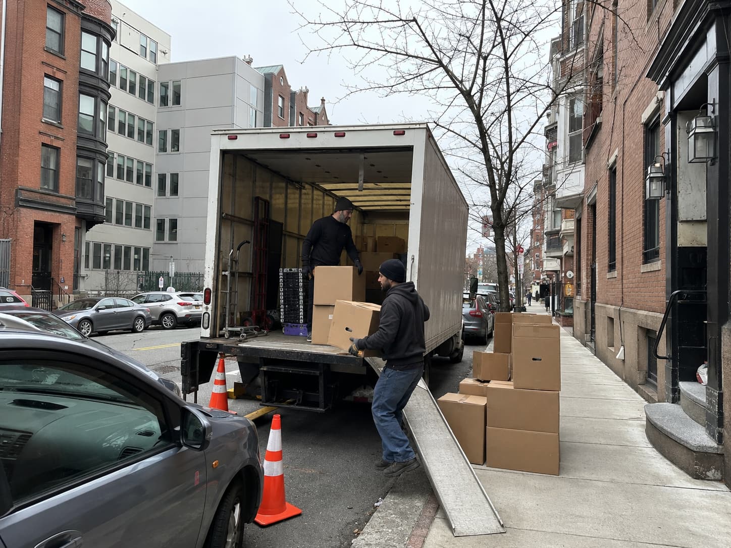 Moving truck parked on a busy Boston street where a parking permit may be needed