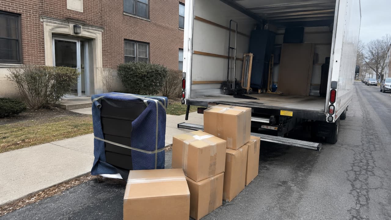 Wrapped dresser and sealed moving boxes prepared for an interstate shipment